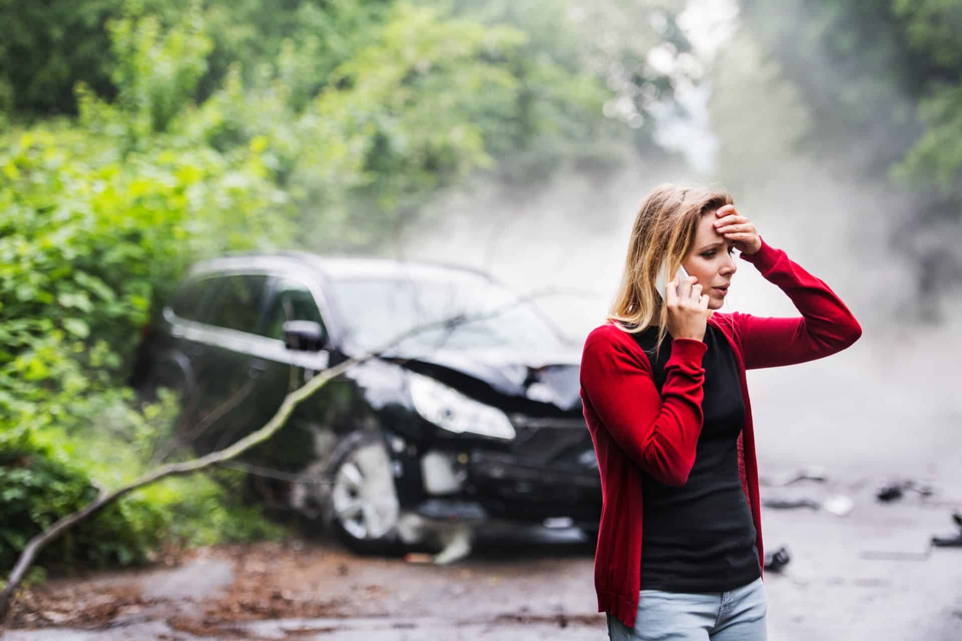 Young Woman Calling With Her Car Crashed In Background